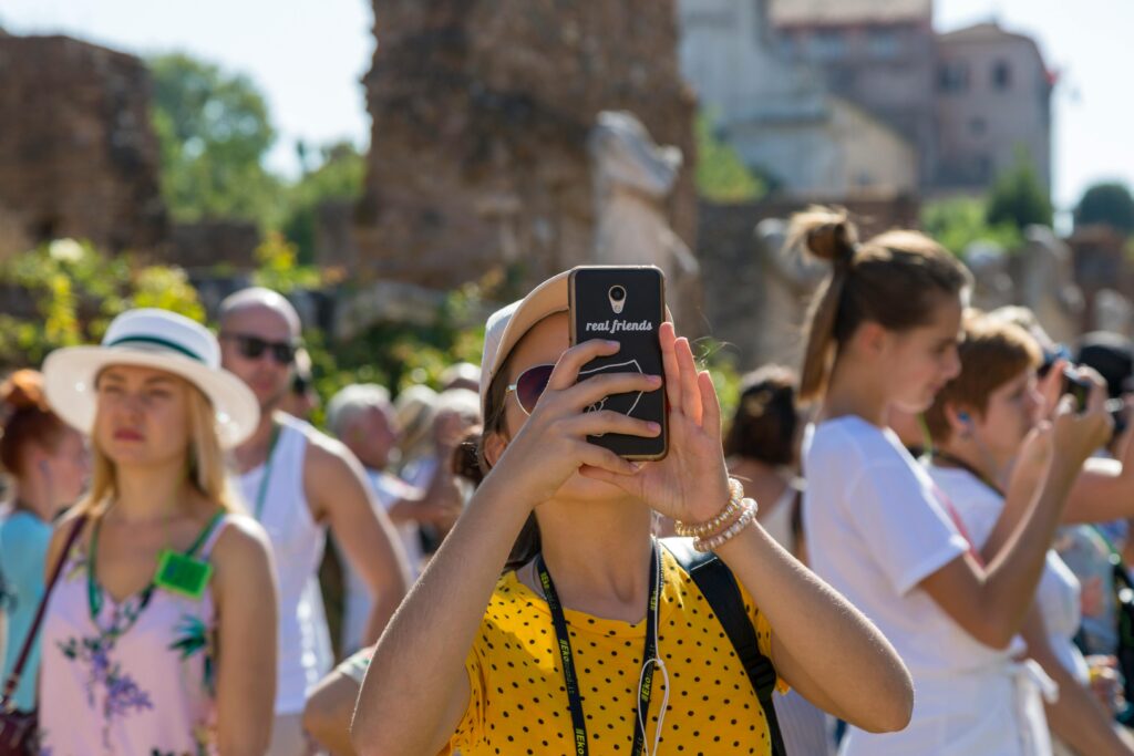 pexels photo 33596225 33596225 A group of tourists using smartphones to photograph historical ruins on a sunny day.